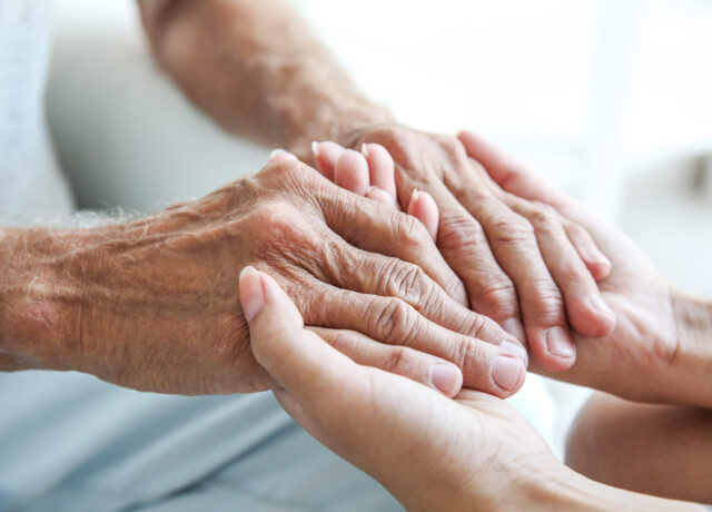 Close up of two people holding hands